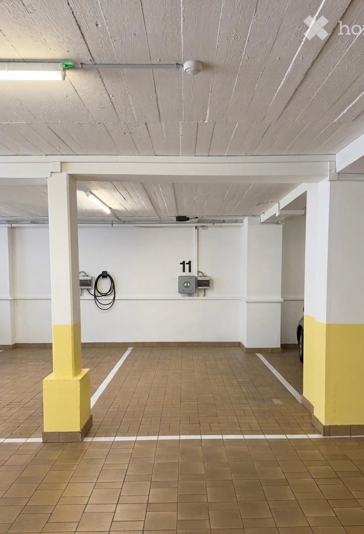 {"visible_features": ["Garage"], "type": "Garage", "objects": [], "description": "Clean, organized underground parking space with numbered bay (11), tiled floor, white walls, and support columns.", "localized_descriptions": {"EN": "Clean, organized underg