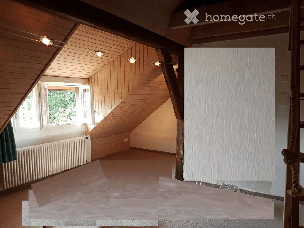 Empty attic room with wooden slanted ceilings, exposed wooden beams, large windows, and a radiator. No furniture or equipment present.
