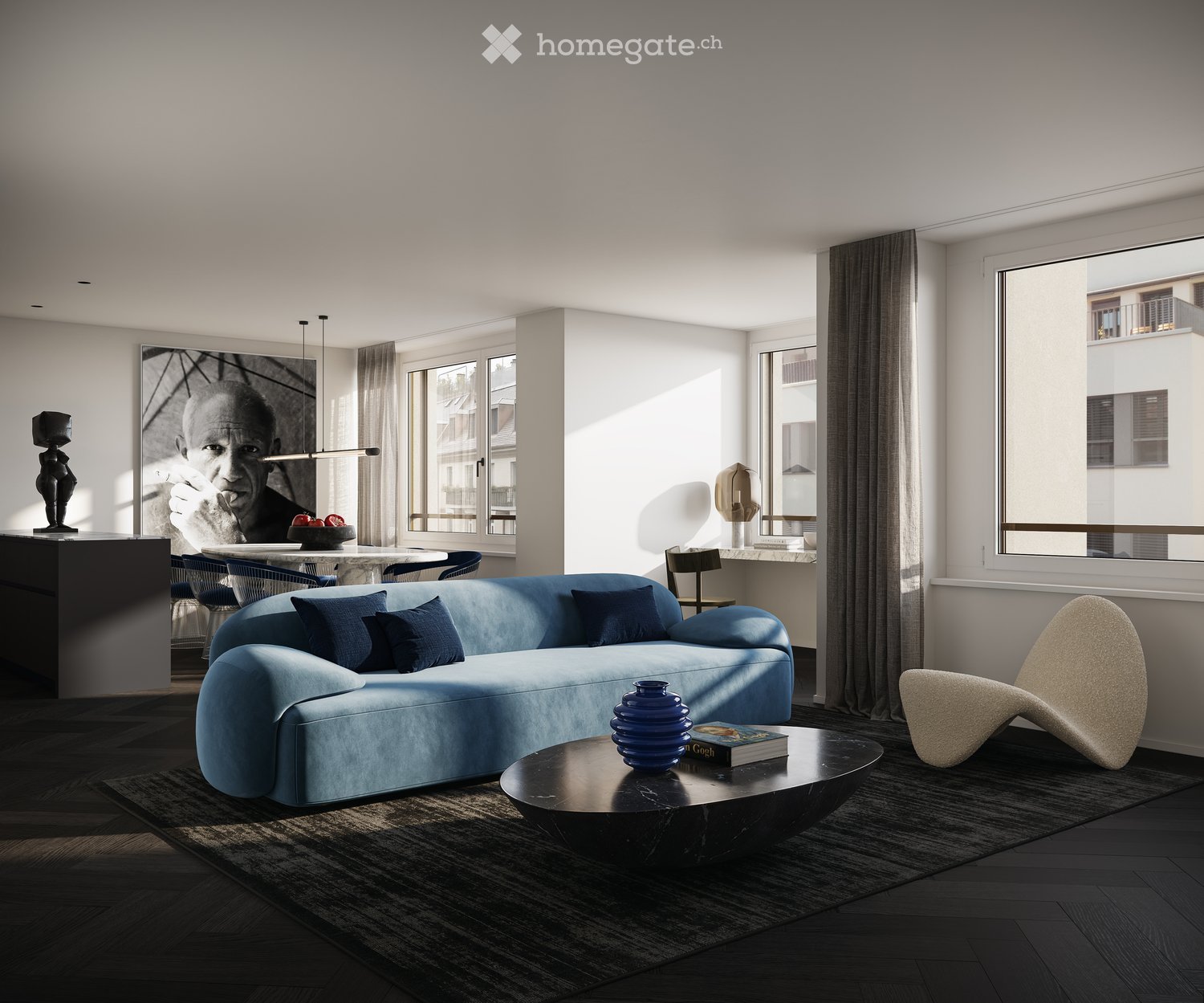 Modern living room with a blue sectional sofa, dark coffee table, and large windows. Features include a sleek black side table, decorative vases, and a contemporary chair.