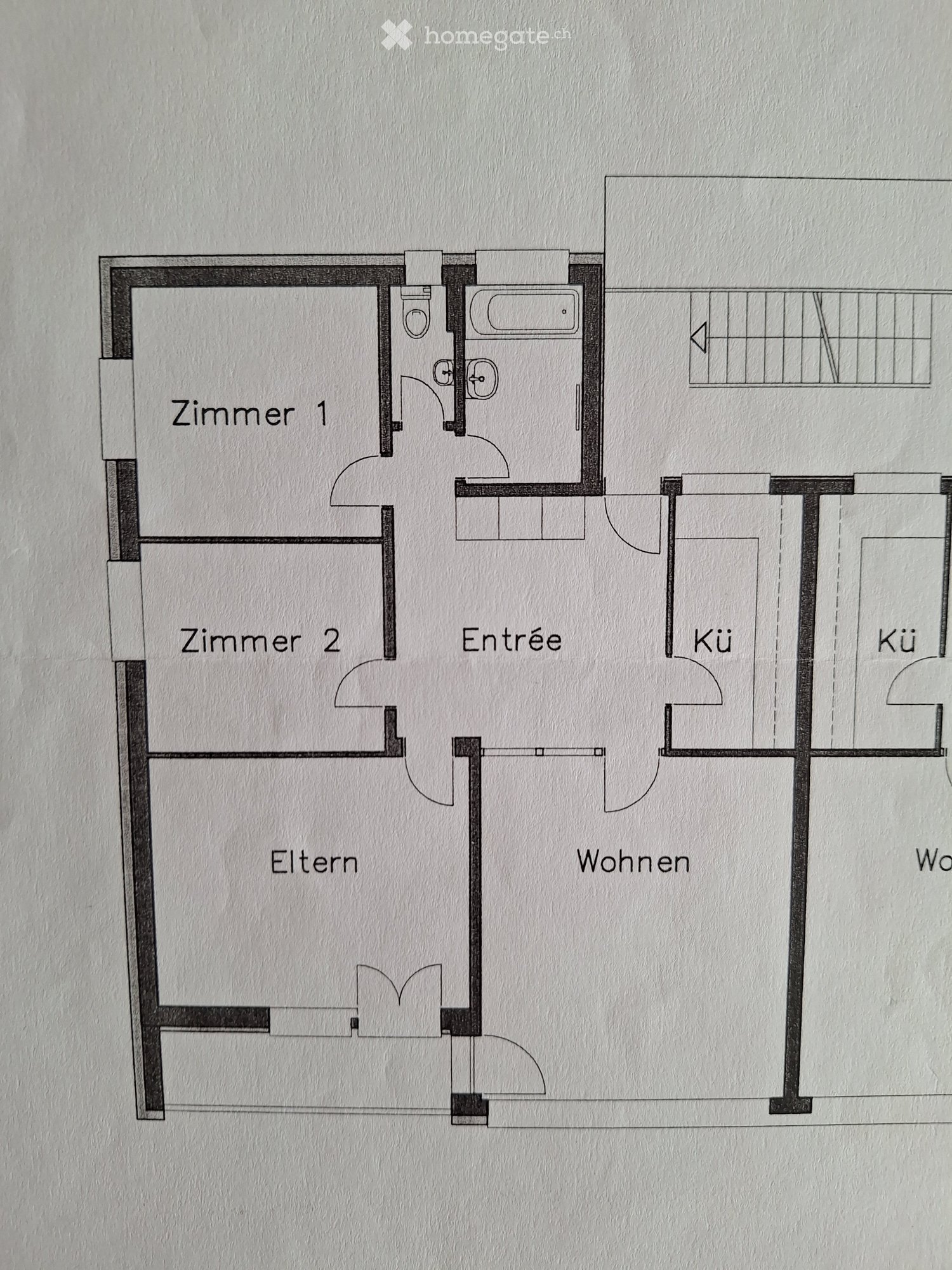 Floor plan showing a layout with two bedrooms, a living area, an entrance, and two kitchen areas.