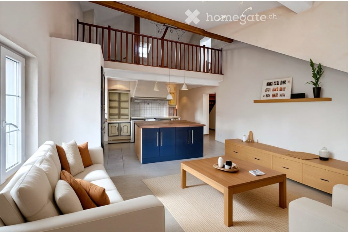 Open-plan living and dining area with a white sofa, wooden coffee table, sideboard, and kitchen island. Exposed wooden beams and pendant lights are visible, along with a shelf displaying photos and a plant.