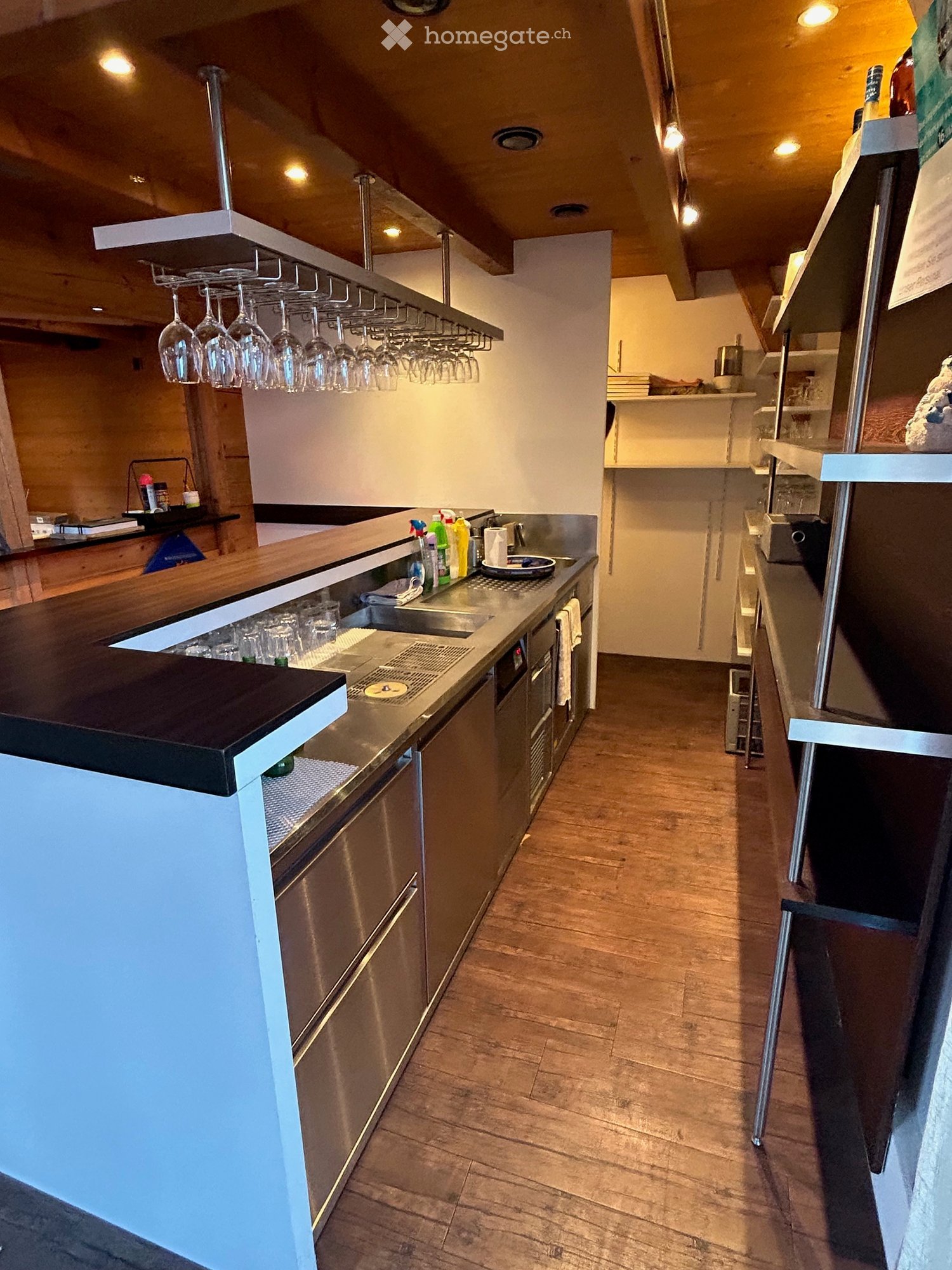 large kitchen counter, stainless steel dishwasher, gas stove, wine rack, large sink, shelves