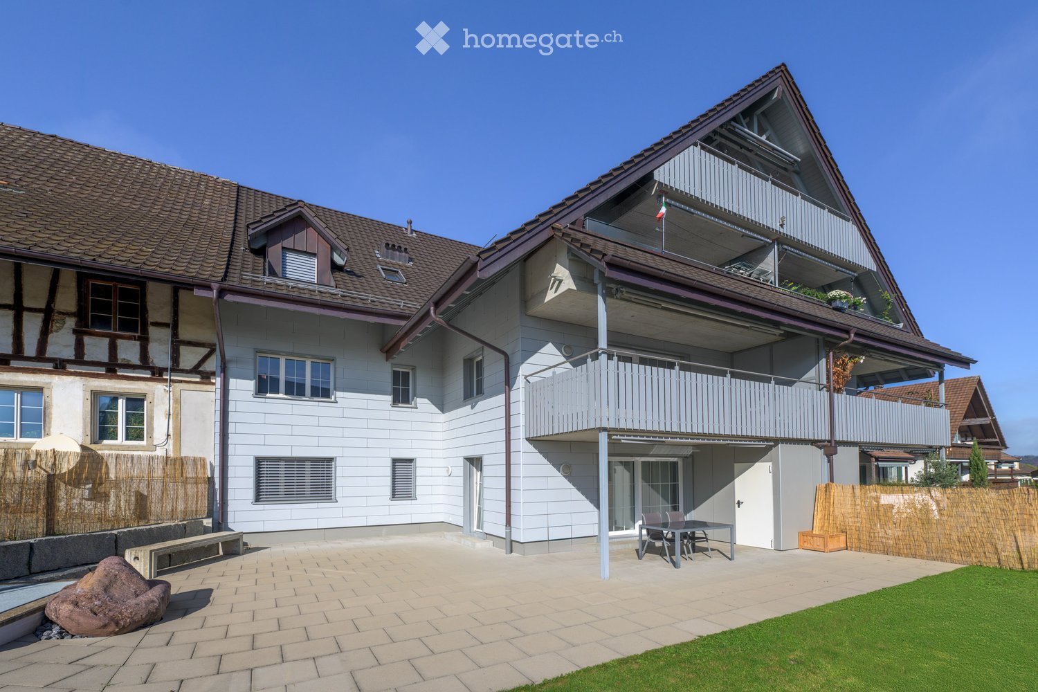 two story house, brown roof, white walls, tiled terrace, balcony