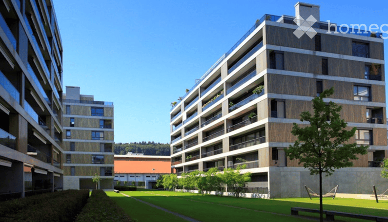 Apartment complex, modern architecture, balconies, green areas, landscaped lawn