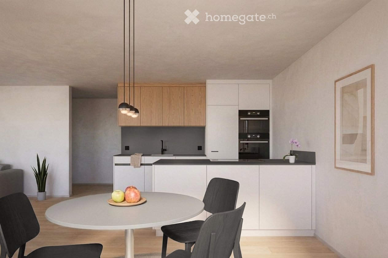 Modern kitchen with white cabinets, a round dining table with chairs, a potted plant, and a framed picture on the wall.