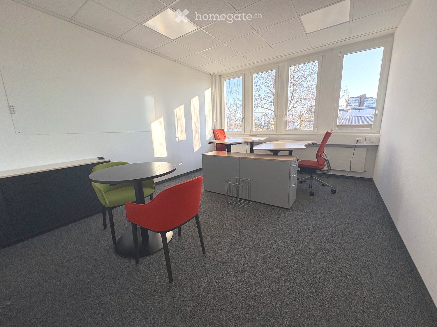 empty office room with desks, chairs, whiteboard, windows