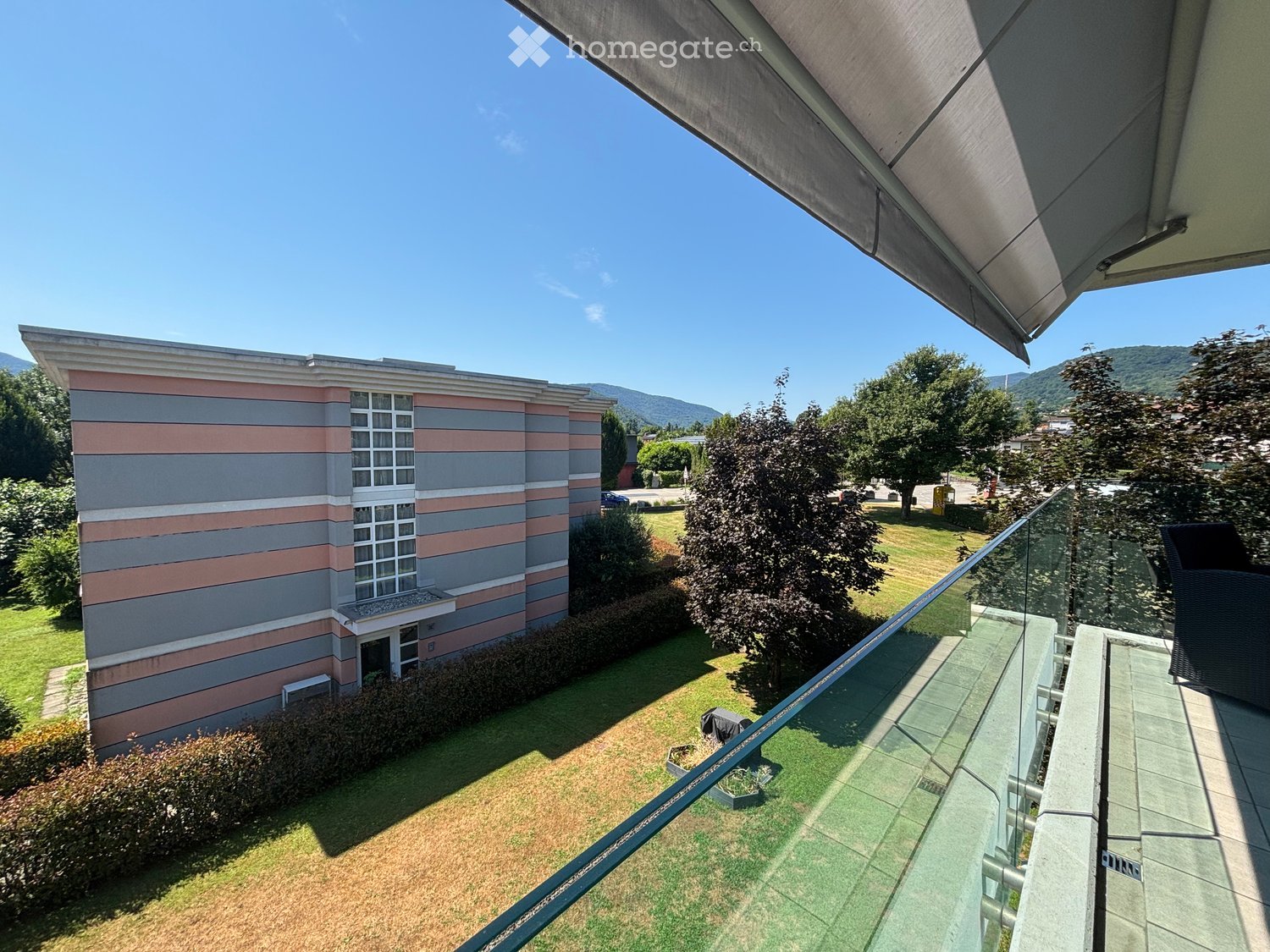 Apartment building with a balcony and a view of the surrounding landscape