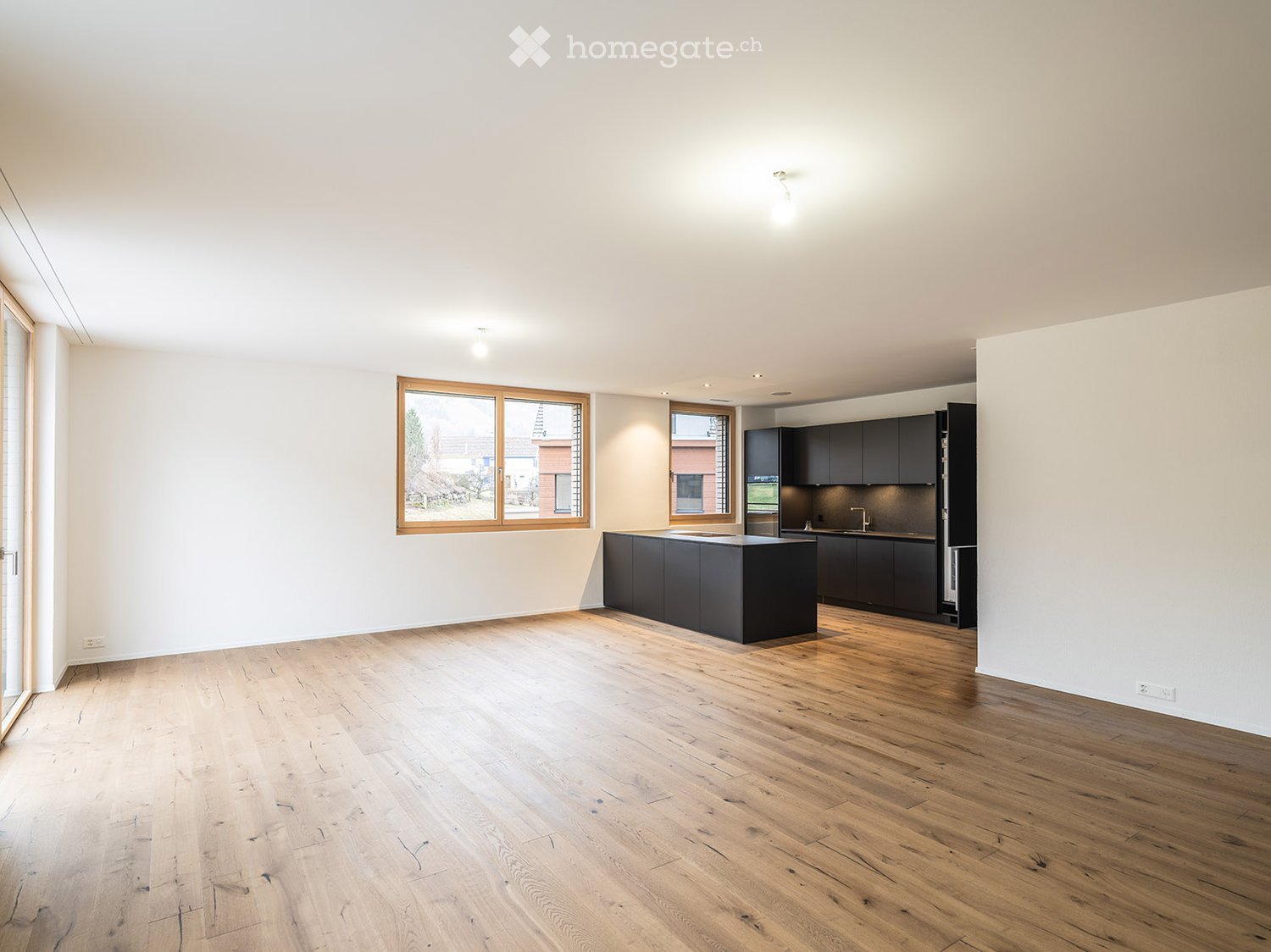 Open concept layout, hardwood floors, kitchen island, large window, kitchen sink, stainless steel appliances