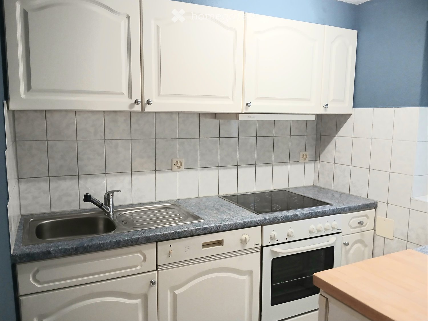 white cabinets, blue tiles, stainless steel sink, electric oven, dishwasher, gas stove, gray countertop