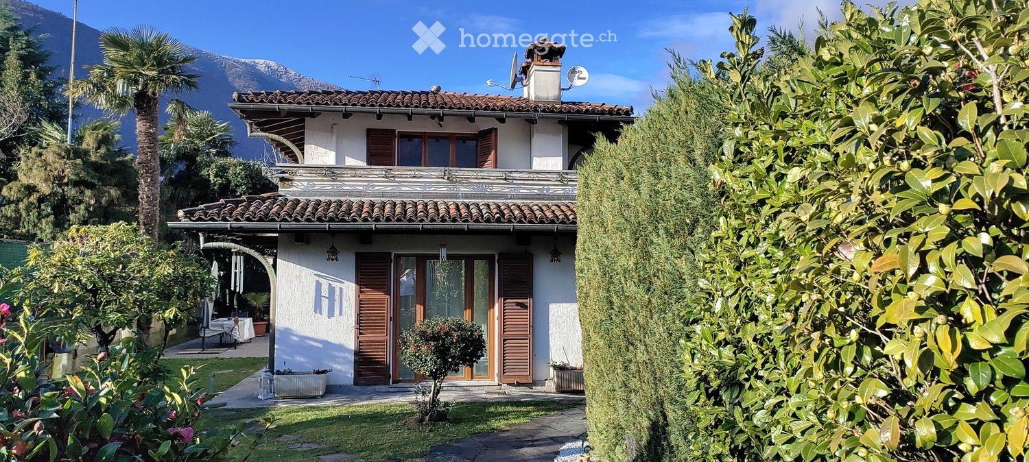 2 story house, terracotta roof, white walls, wooden shutters, terrace, small garden