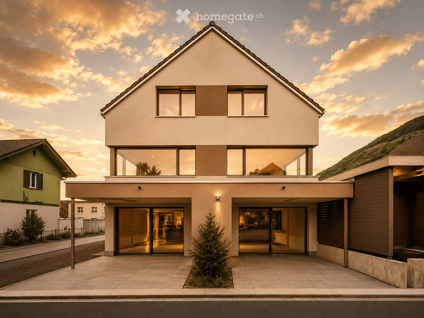 Modern two-story house with large windows, raised ground floor, and contemporary design.