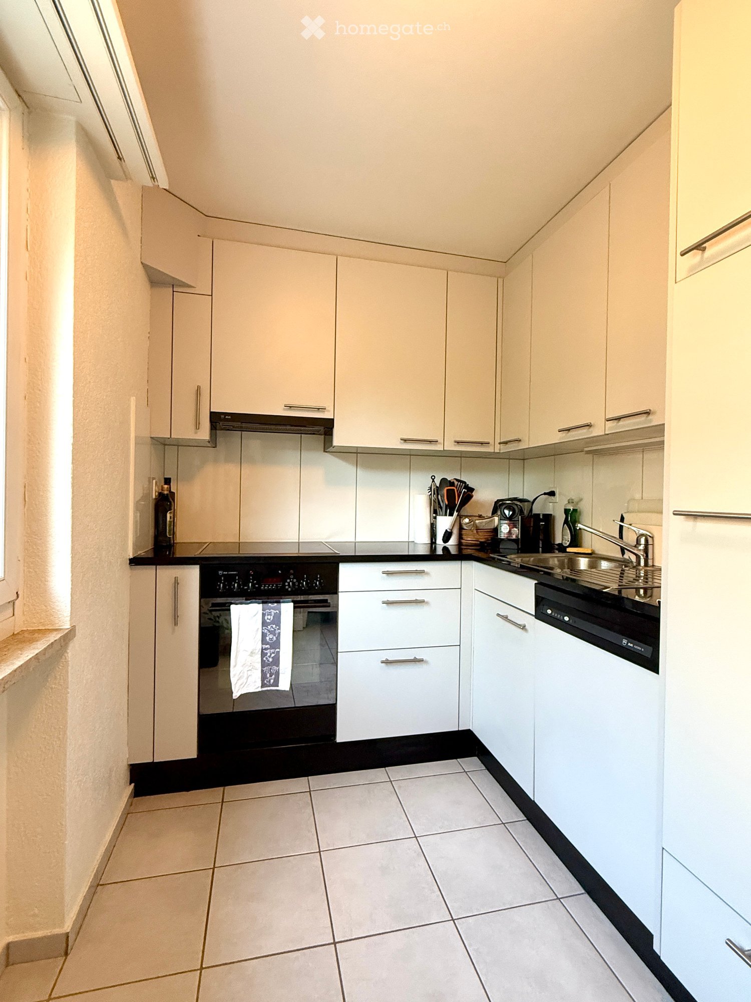 {"type": "Kitchen", "objects": ["oven", "dishwasher", "sink", "faucet", "coffee maker", "bottle", "cupboard", "cupboard", "cupboard", "cupboard", "cupboard", "cupboard", "cupboard", "cupboard", "cupboard", "cupboard", "cupboard", "cupboard", "cupboard", "