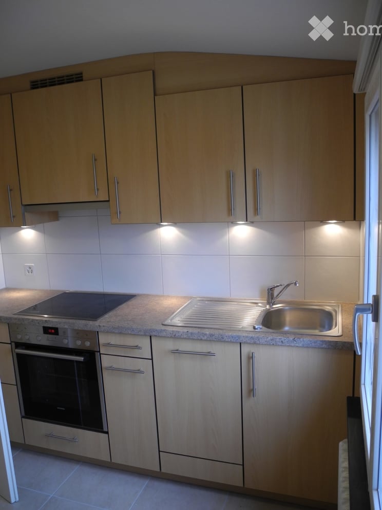 modern kitchen with wooden cabinets, stainless steel sink, electric stove, oven, dishwasher, under cabinet lighting