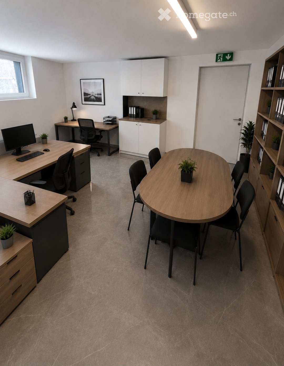 Modern office space with a desk, chair, computer setup, round meeting table, chairs, cabinet, lamp, potted plants, and shelves.