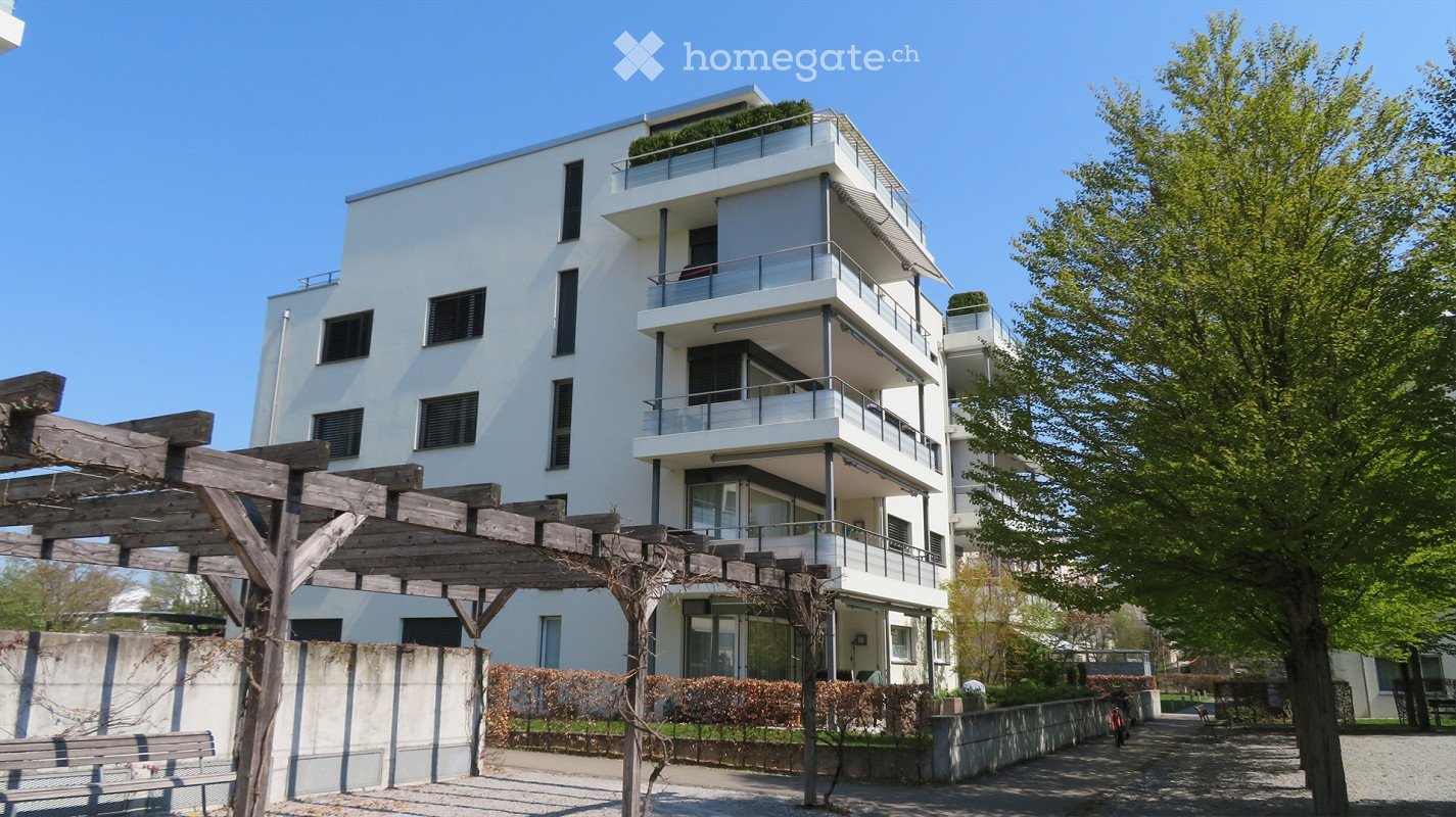 white building, multiple balconies, modern design, wooden pergola, trees, concrete wall