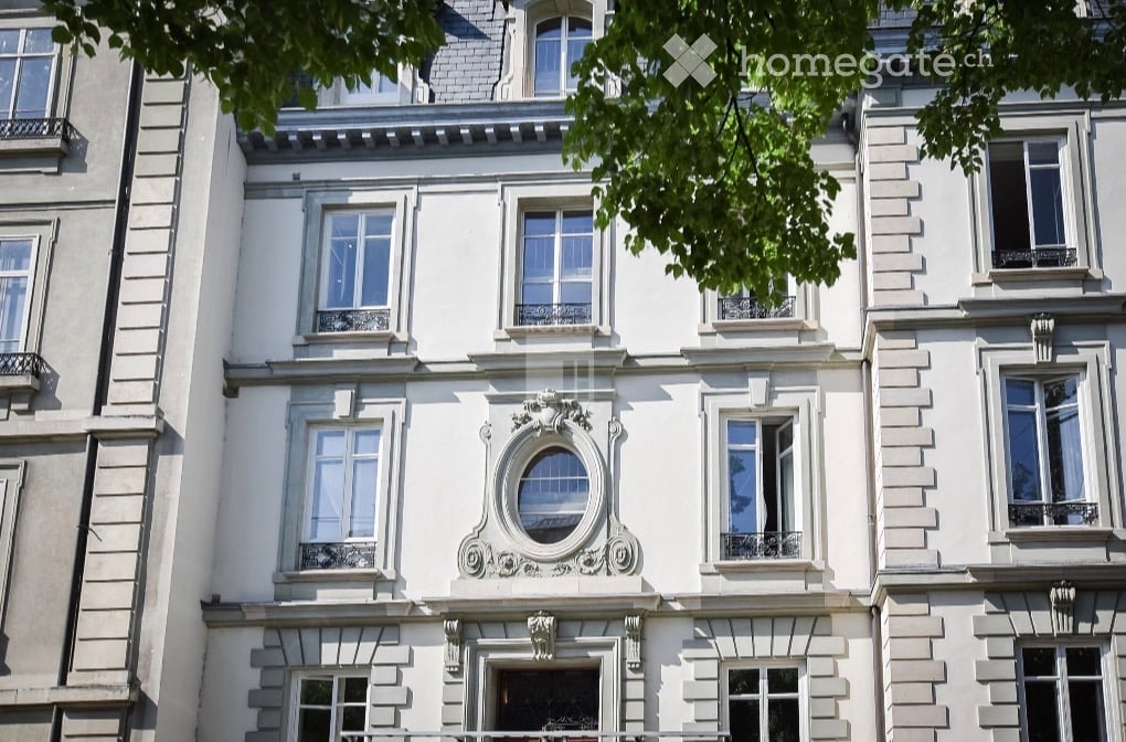 Classic European-style building with ornate facade, multiple windows, decorative stonework, and balconies.