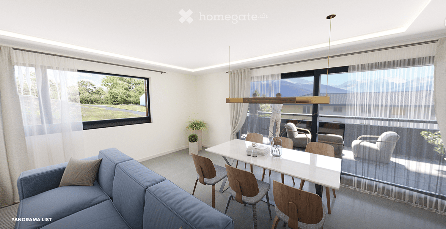 Modern living and dining area with a blue sofa, white dining table, wooden chairs, pendant light, and large windows with a scenic view.