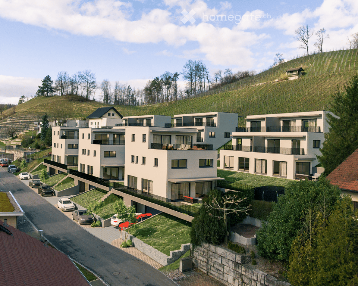 Modern multi-story residential building with balconies, surrounded by greenery and parked cars.