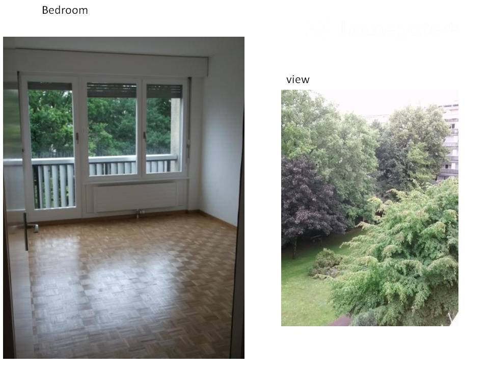Empty bedroom with wooden flooring, large windows, and a view of greenery outside.