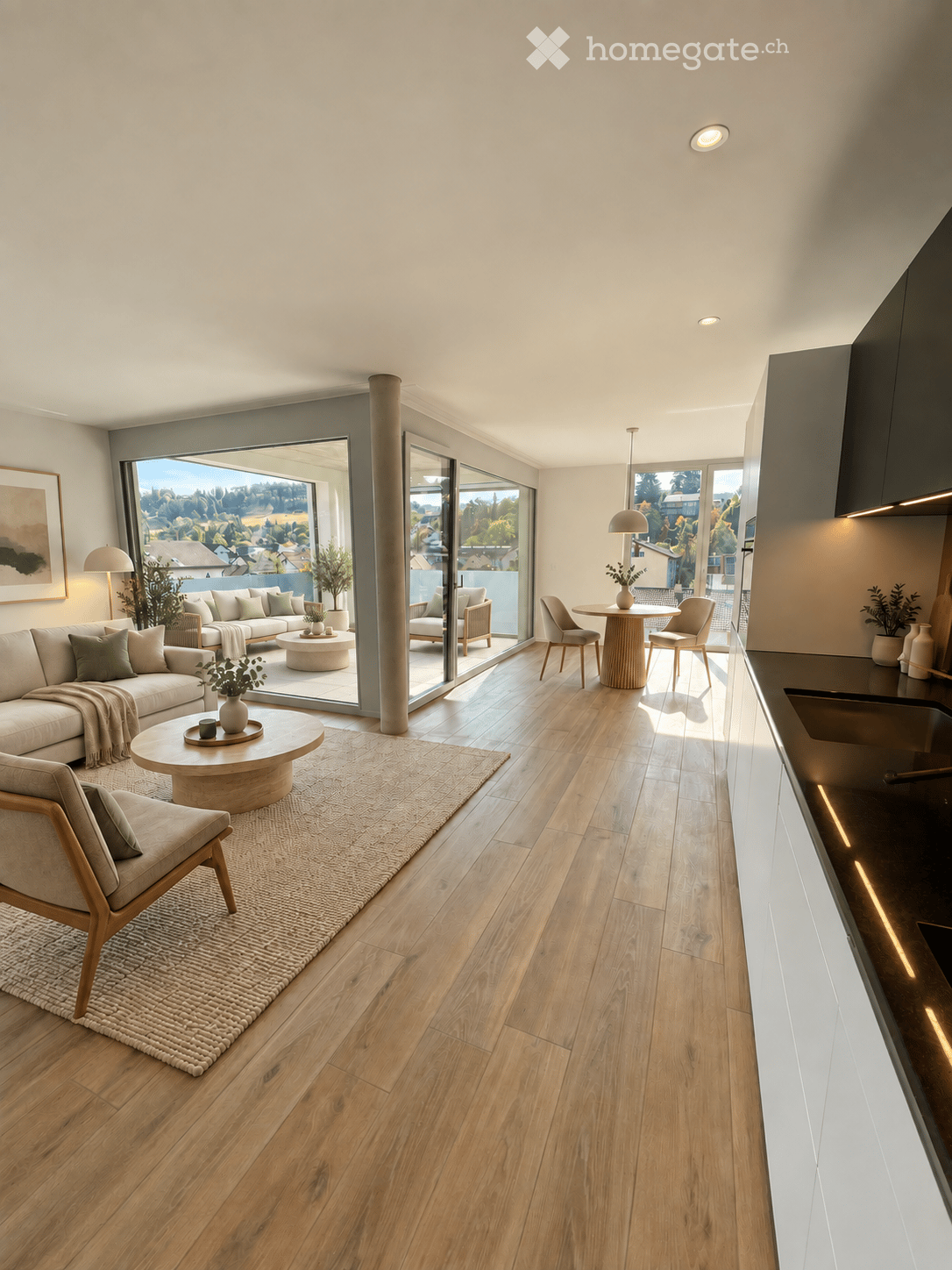 Modern living and dining area with wooden flooring, large windows offering a scenic view, a sofa, coffee table, dining table, chairs, and a kitchen counter.