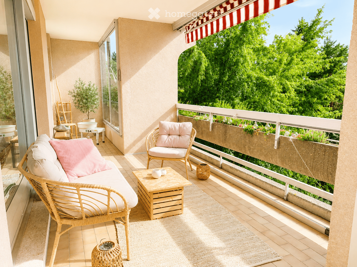 Balcony with a view of greenery, featuring a wicker sofa, a wicker chair, a small wooden table, and decorative items.