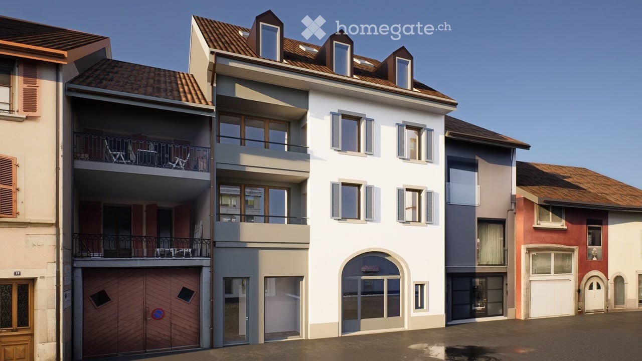 Building. Multi-story residential building with balconies, garage, and multiple windows.