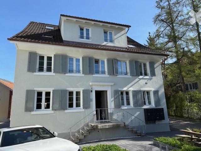 white building, 4 floors, stairs, window, car