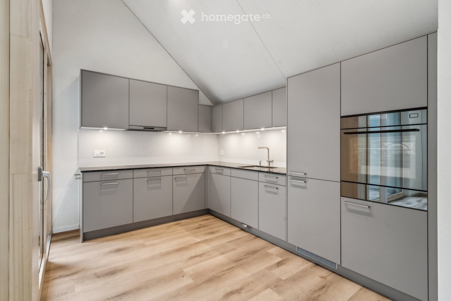 kitchen with wooden floors, gray cabinets, oven, sink, faucet, modern design