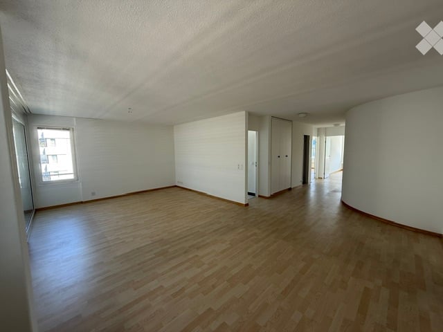 Completely empty room with wooden flooring and white walls. No furniture or equipment visible.