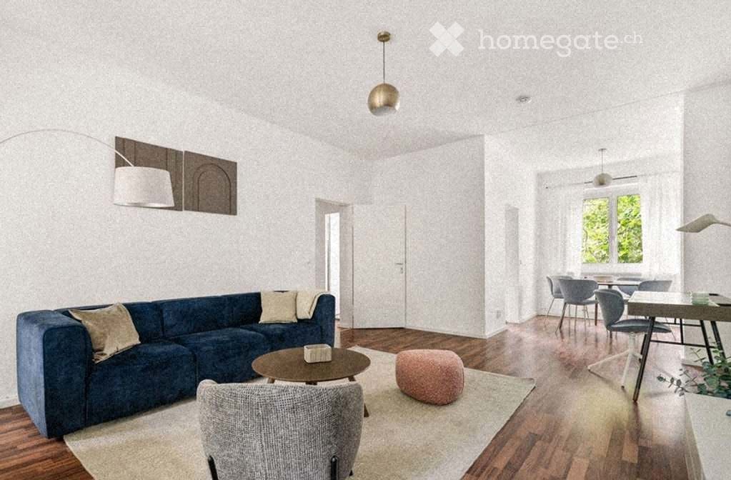Modern living room with a blue sectional sofa, coffee table, grey armchair, round stool, dining table with chairs, and pendant lighting.