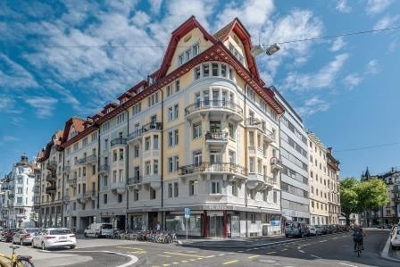 Multi-story residential building with balconies, ornate facade, and classic architectural details.