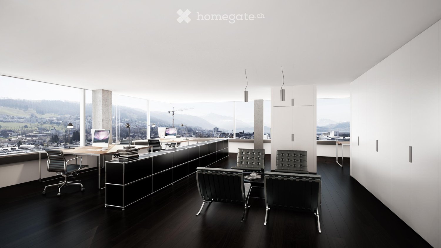Modern office space with large windows offering a scenic view, featuring desks, chairs, screens, and cabinets.