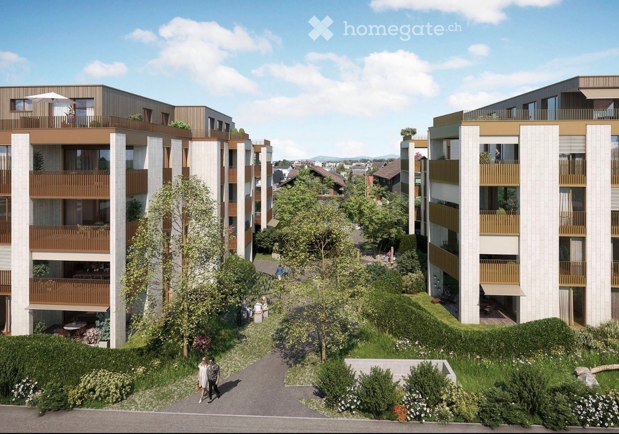 Modern multi-story residential building with balconies, surrounded by greenery and pathways.