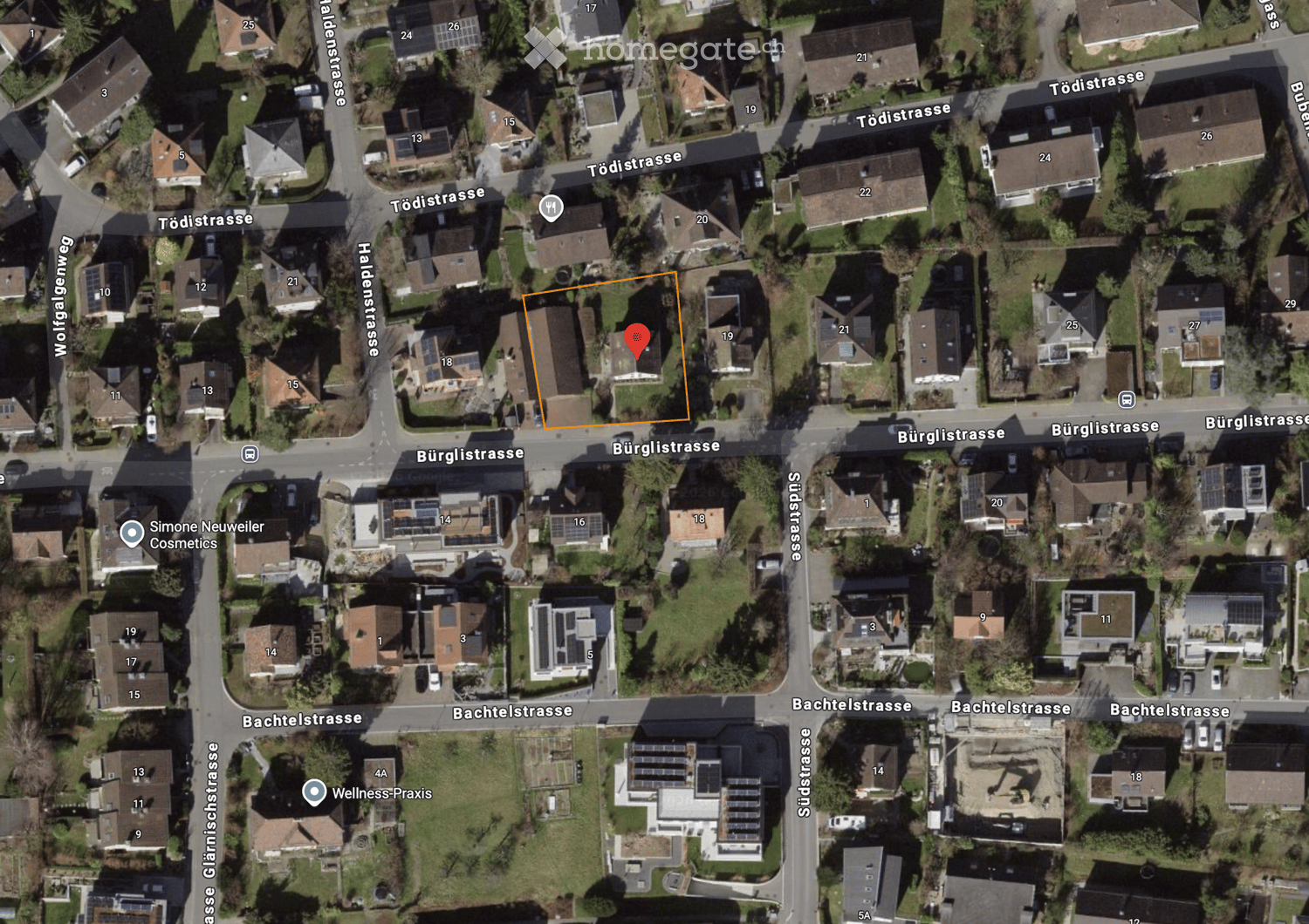 Aerial view of a residential area with multiple houses, numbered addresses, and surrounding streets.