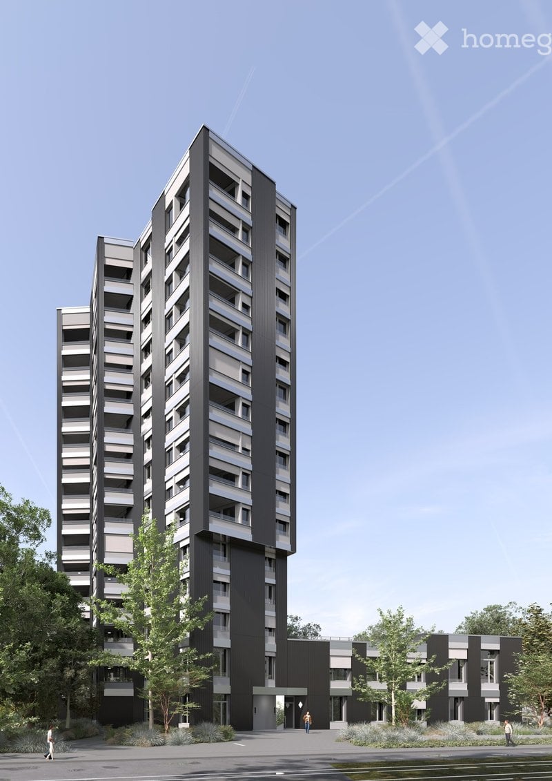 Modern high-rise apartment building with sleek black and grey facade, multiple floors, balconies, and surrounding greenery.
