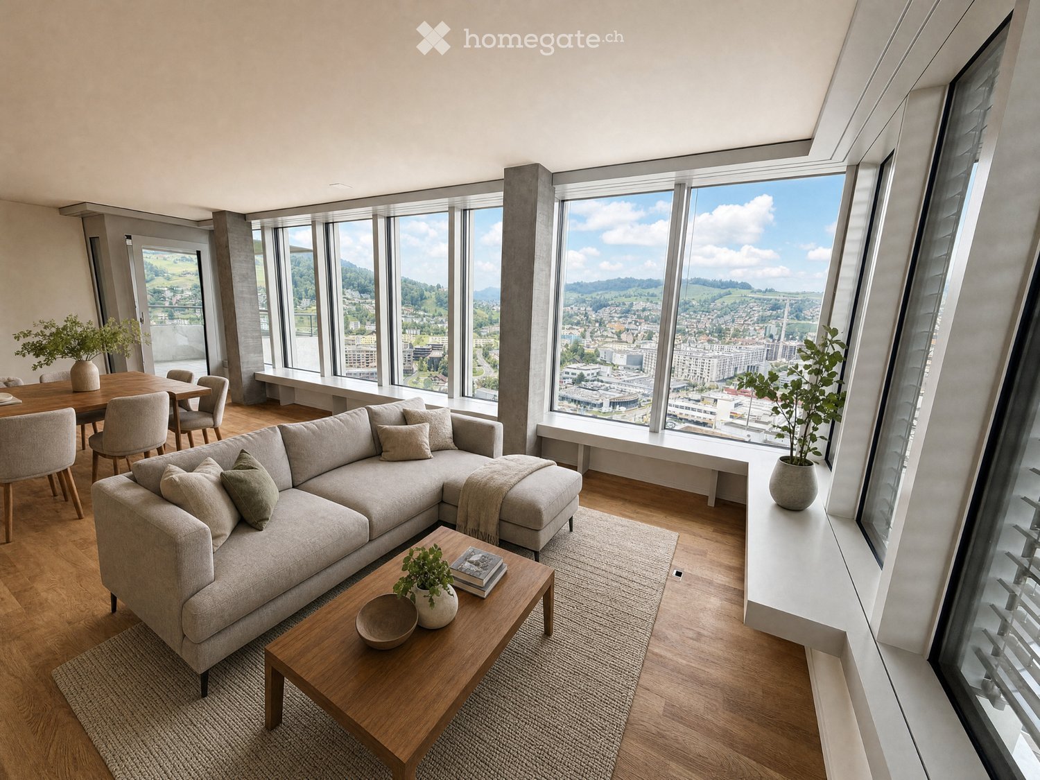 Modern living room with large windows offering a scenic view, featuring a grey sectional sofa, wooden coffee table, dining area with chairs, and decorative plants.