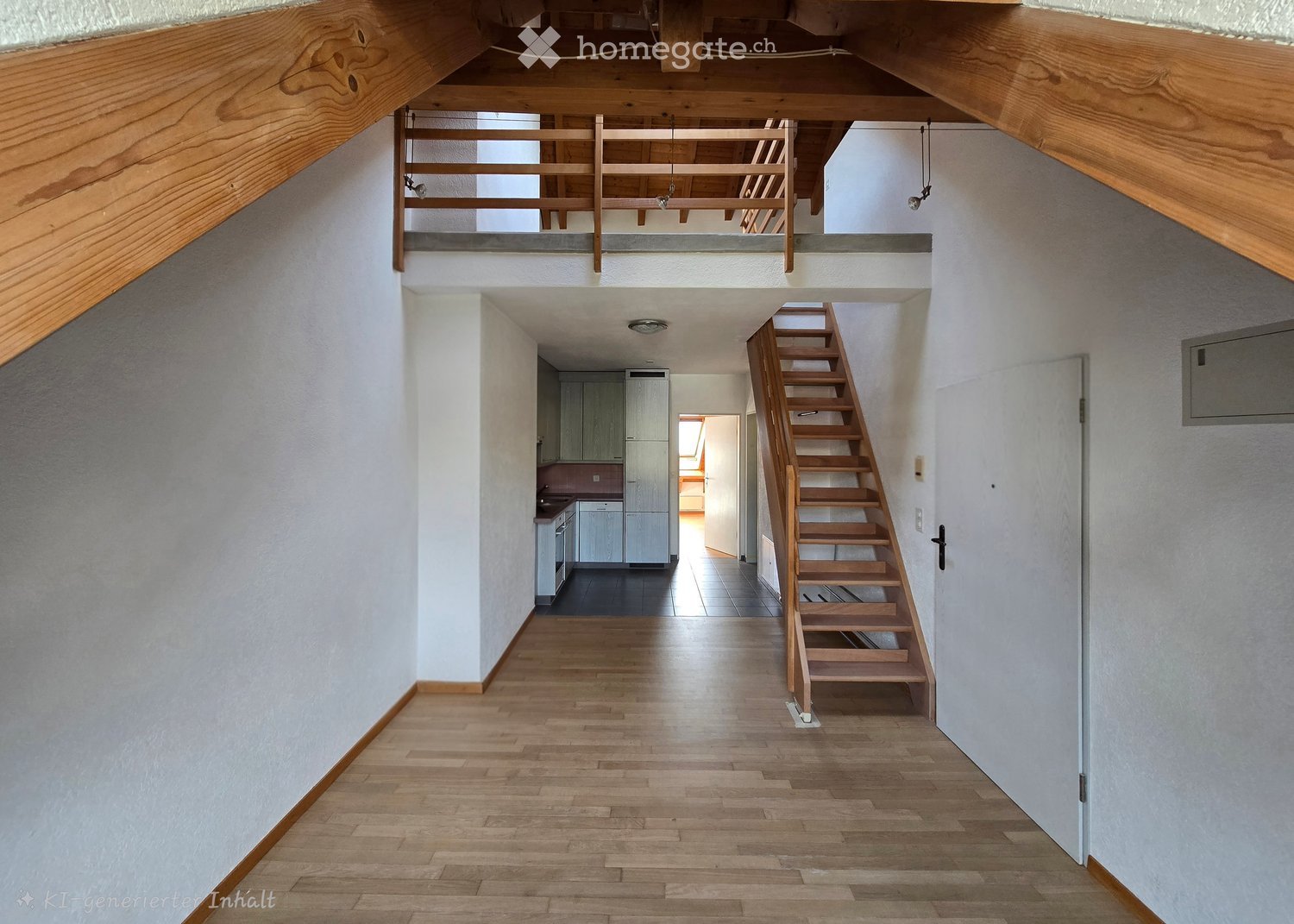 Bright hallway with wooden flooring, white walls, and a staircase leading to an upper level. The hallway features a wooden staircase, a small landing area, and a view into a kitchen area with white cabinets and a refrigerator.