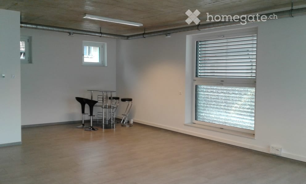 empty room, white walls, wooden floor, three stools, small table, large window, two smaller windows