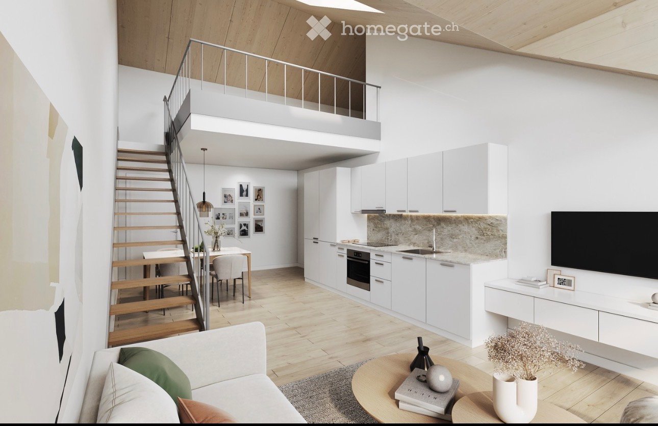 Modern open-plan living and dining area with a raised loft level, white kitchen cabinets, a sofa, coffee table, dining table, and decorative items.
