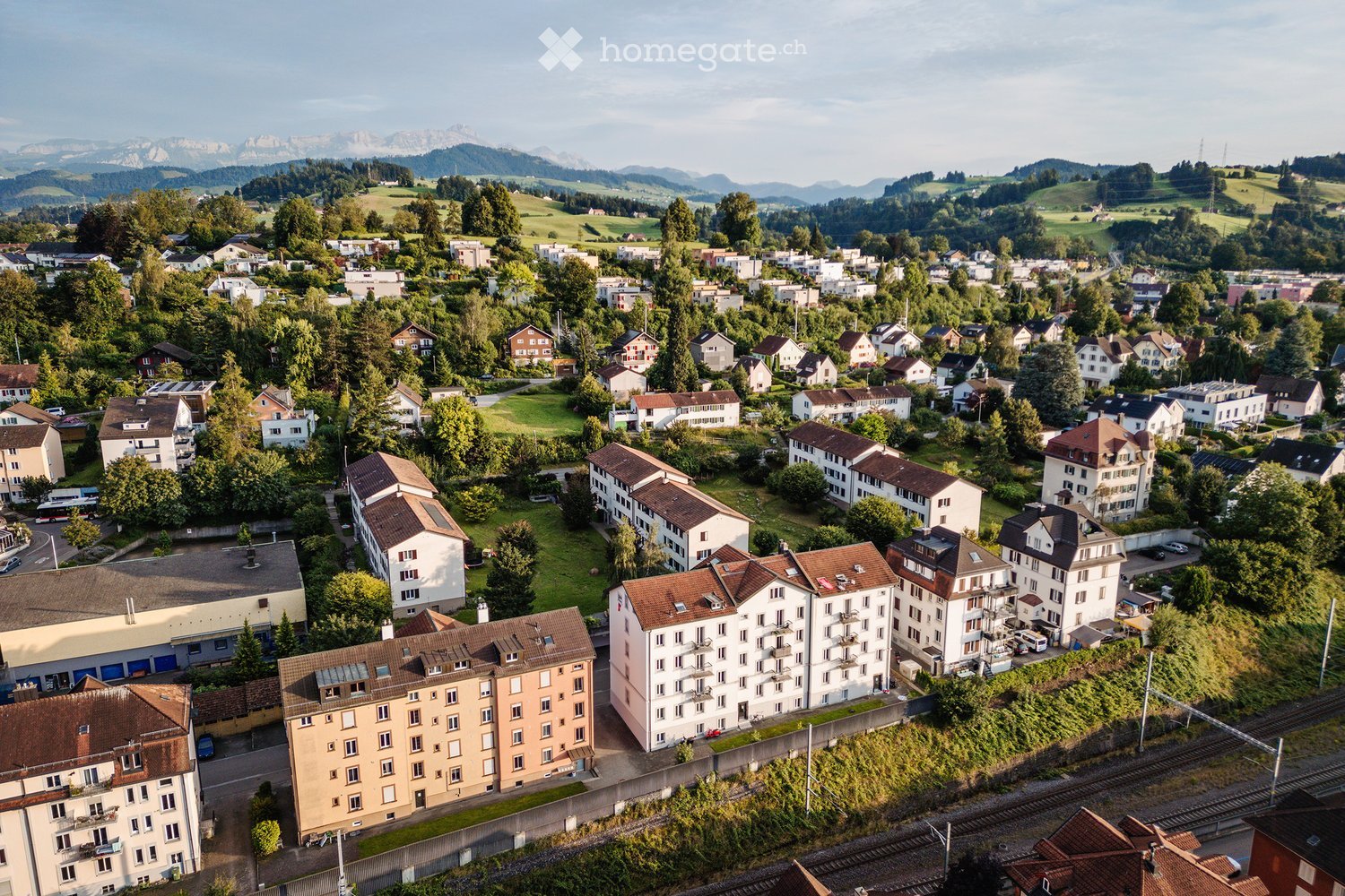 group of buildings, many residential buildings, mountains in the background