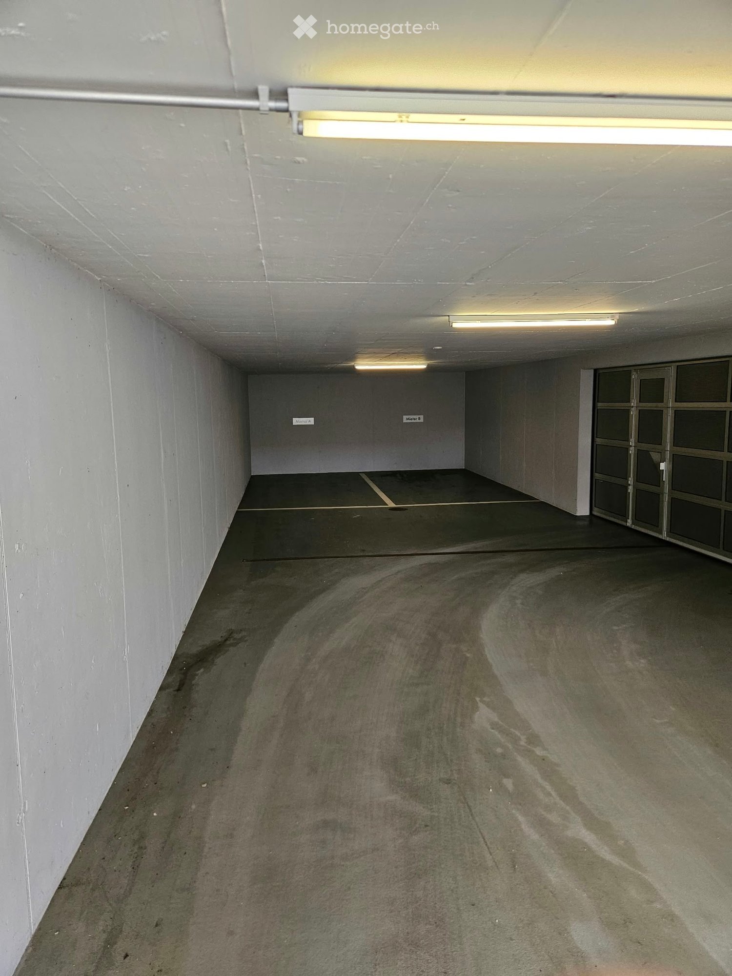 {"type": "Garage", "objects": [], "description": "Empty underground garage with concrete floors, white walls, fluorescent lighting, and a single door at the far end.", "localized_descriptions": {"EN": "Empty underground garage with concrete floors, white