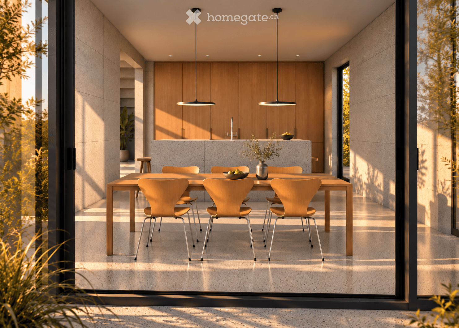 Modern, minimalist dining area with a wooden dining table, six light-colored chairs, pendant lights, and a sleek kitchen area with cabinets and a faucet.
