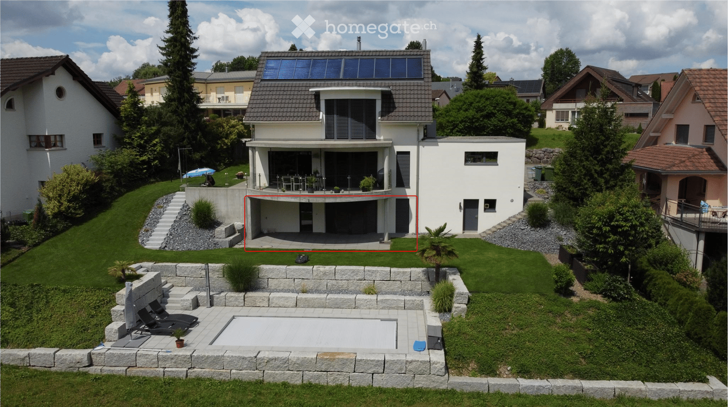 Modern two-story house with solar panels, garage, swimming pool, and well-maintained garden.