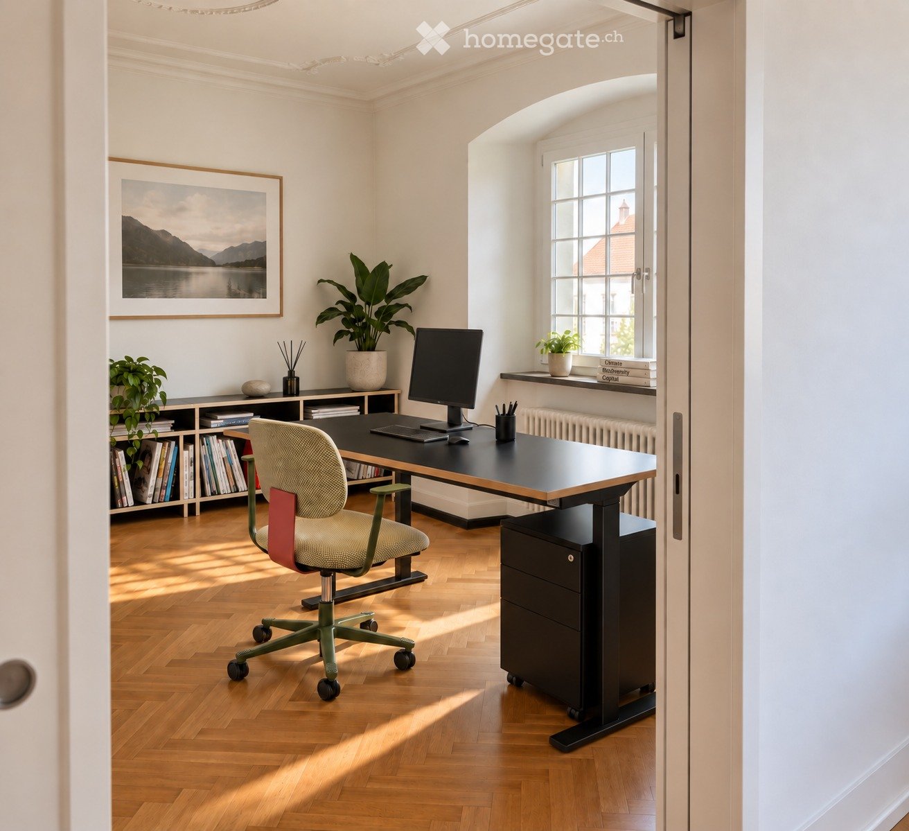 A modern, well-lit office space with a wooden floor, a large desk, a comfortable chair, a computer screen, a cabinet with books, and decorative plants.