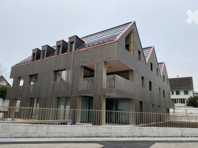 Modern architectural design, copper roof, wooden facade, large windows, balcony, metal fence