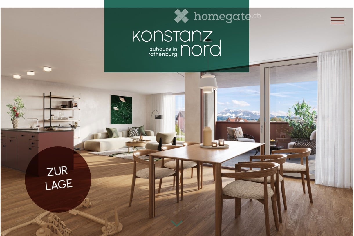 Open-plan living and dining area with modern furniture, large windows offering a scenic view, and a small kitchen section.
