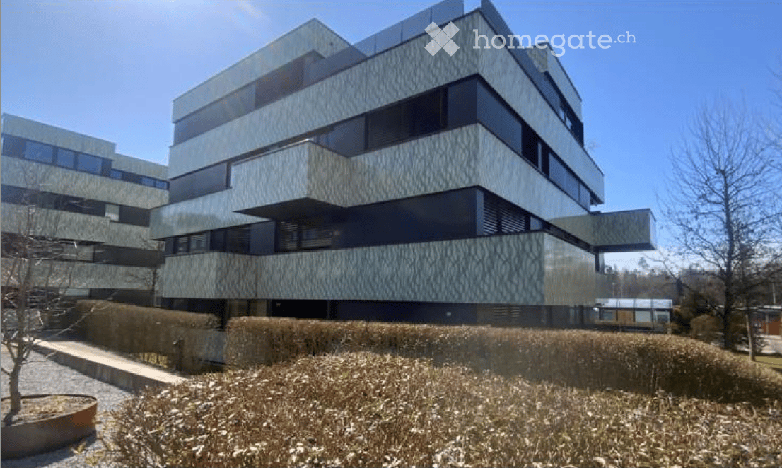 Modern multi-story building with a sleek, contemporary design featuring large windows and geometric patterns on the facade.