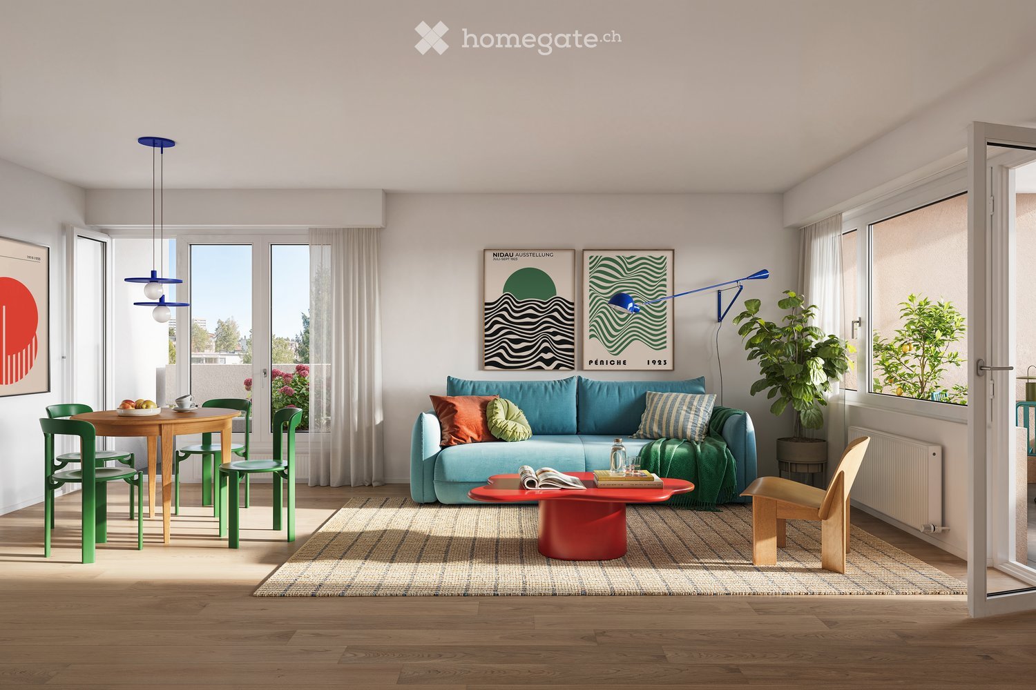 Bright living room with wooden flooring, large windows, a blue sofa with colorful cushions, a red coffee table, a small dining area with a round table and green chairs, and modern lighting fixtures.
