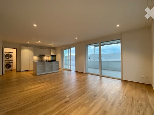 Open kitchen with wooden floors, granite countertops, glass sliding doors, built-in appliances