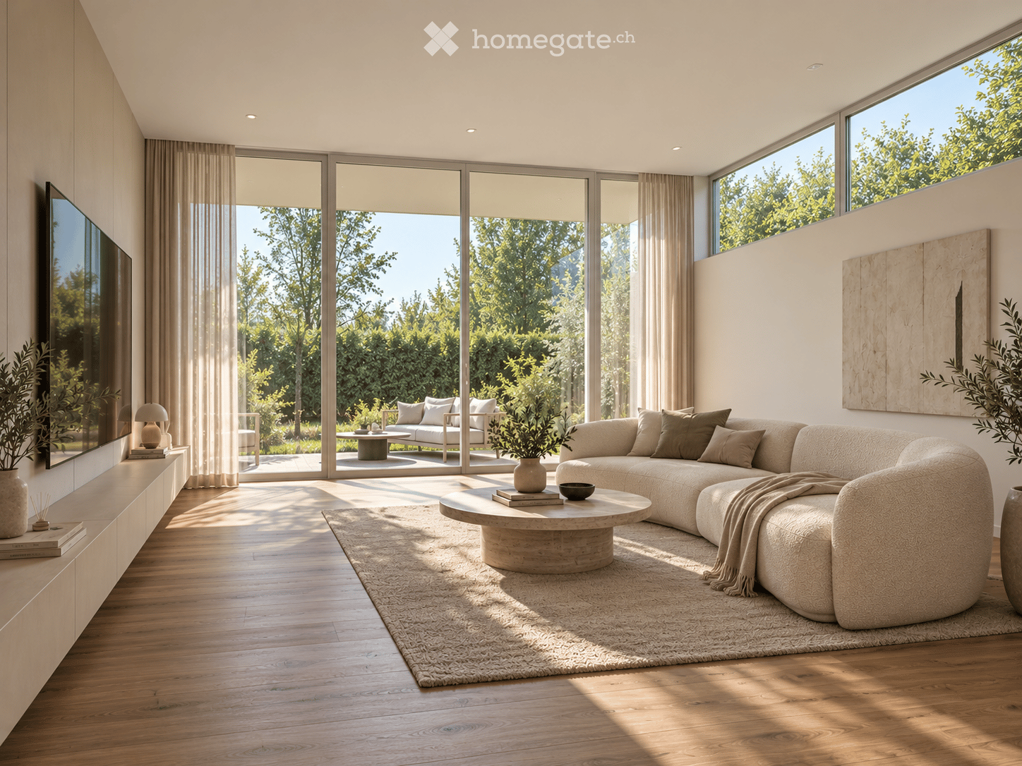 Modern living room with large windows and a view of greenery, featuring a sectional sofa, coffee table, table lamp, and television.